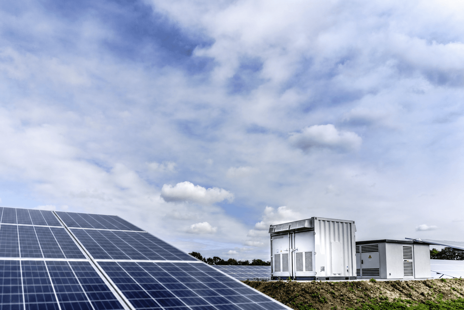 Battery energy storage equipment beside a solar panel installation
